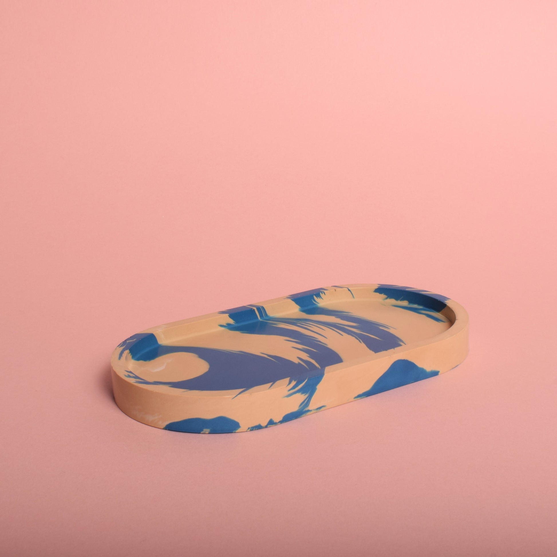 A blue and beige marble effect oval trinket tray.