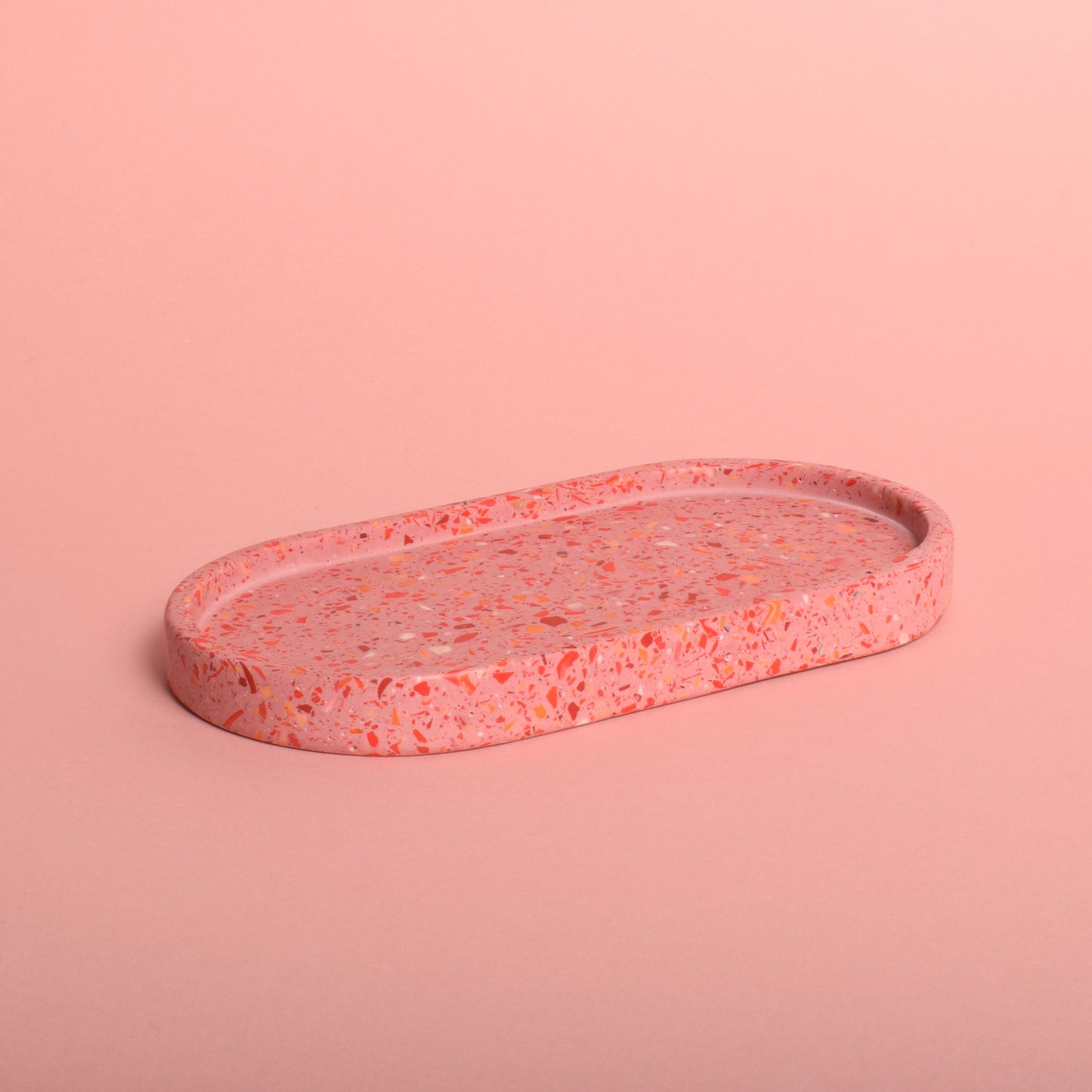 An oval pink terrazzo trinket tray