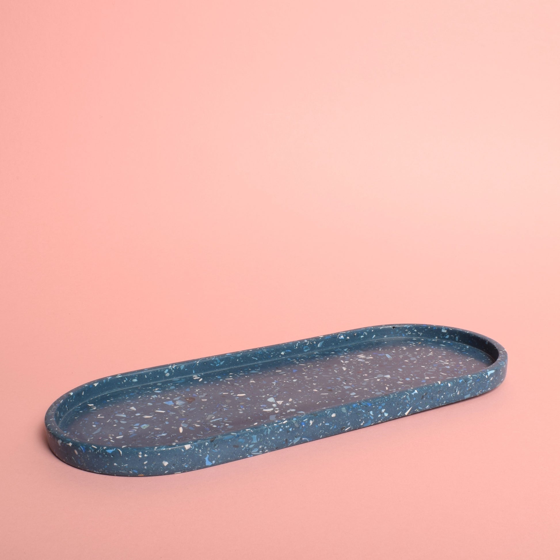 A large oval blue terrazzo trinket tray